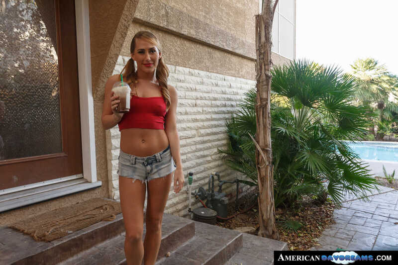 Naughty America Carter Cruise porn: Carter Cruise is holding a drink in her hand.