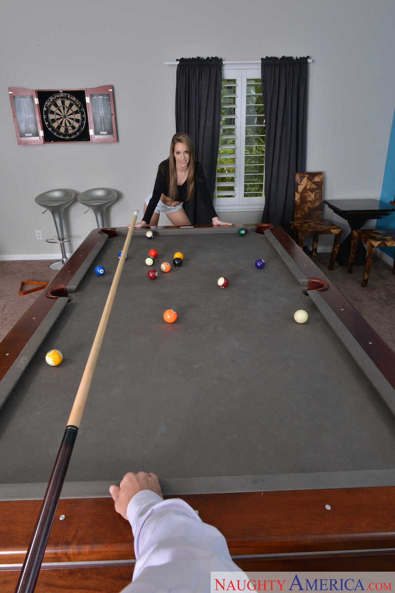 American Daydreams Kimmy Granger porn scene 'Natural cutie Kimmy Granger plays strip pool with client before taking his balls on the table ' - Kimmy Granger is playing pool with a cue stick.