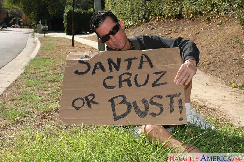 American Daydreams Lexi Belle porn scene 'Lexi Belle gets fucked by a big cock' - Lexi Belle is holding a sign that says Santa Cruz or Bust.