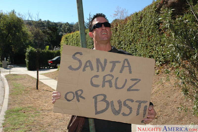 In the Lexi Belle Naughty America porn scene 'Lexi Belle gets fucked by a big cock' from American Daydreams, Lexi Belle is holding a sign that says Santa Cruz or Bust.