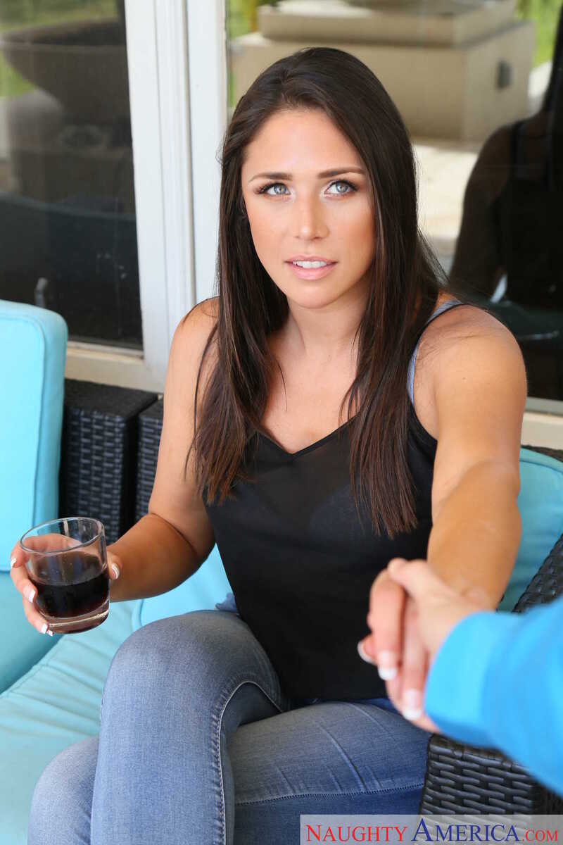 In the Anna Morna I Have a Wife porn scene 'Tall Brunette Anna Morna Fucks You Good', Anna Morna is holding a glass of wine in her hand.