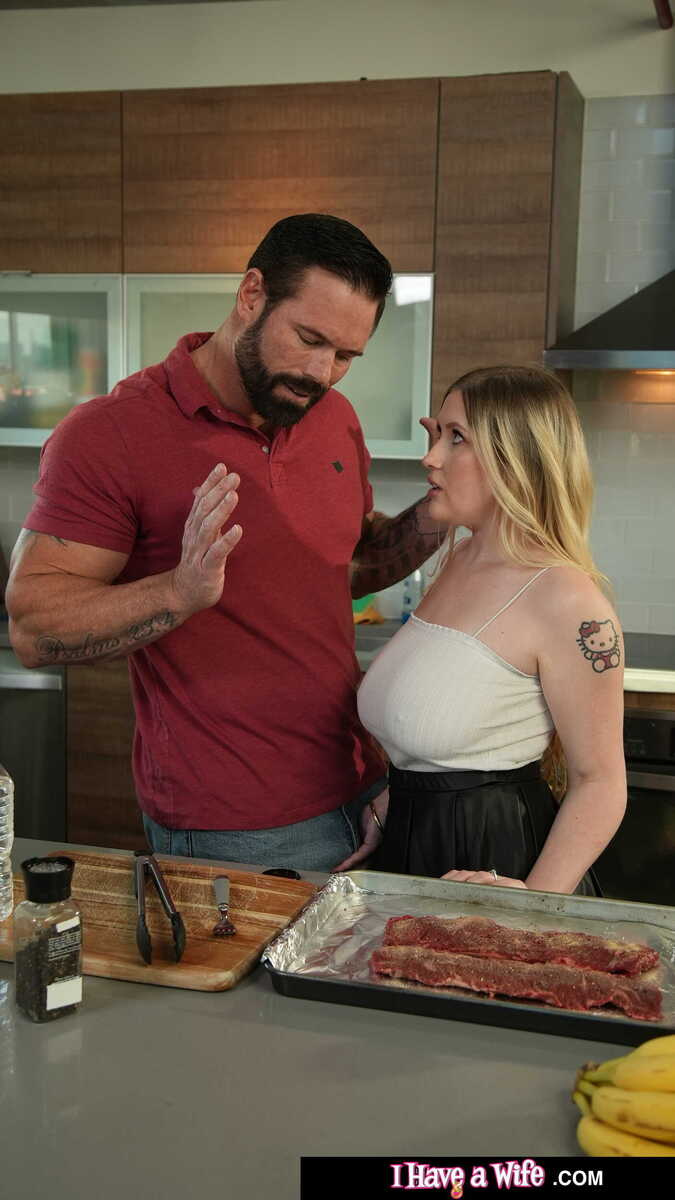 In the Emma Shay Naughty America porn scene 'Busty Blonde Emma Shay loves to work some big meat' from I Have a Wife, Emma Shay is cooking a steak with her husband in the kitchen.