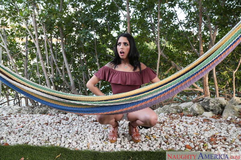 In the Vanessa Sky Latin Adultery porn scene 'Vanessa Sky fucking in the couch with her bubble butt', Vanessa Sky is kneeling on rocks with a hammock behind her.