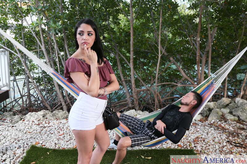 In the Vanessa Sky Naughty America porn scene 'Vanessa Sky fucking in the couch with her bubble butt' from Latin Adultery, Vanessa Sky is standing next to a hammock with a man in it.