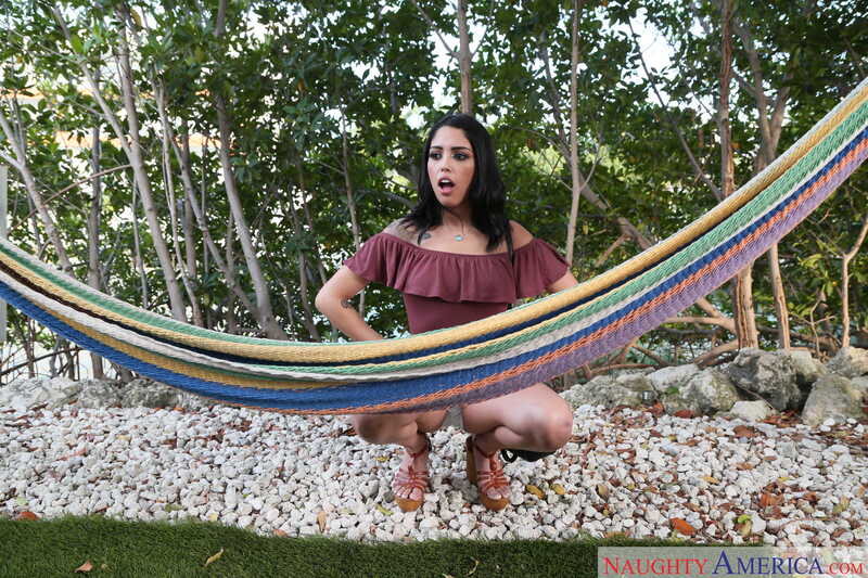 Naughty America Vanessa Sky porn: Vanessa Sky is on a hammock in a wooded area.