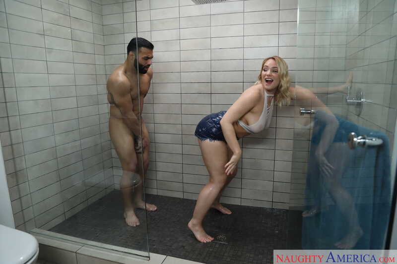 Scene from Naughty America Hadley Mason porn video 'Hadley Viscara fucking in the bathroom with her tattoos' where Hadley Mason is naked in a shower with a man.