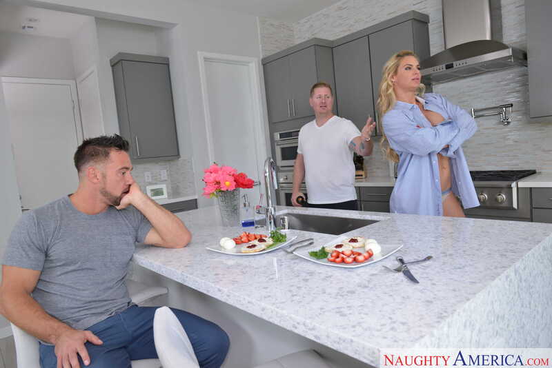 Naughty America Phoenix Marie porn: Phoenix Marie is in the kitchen with two men.