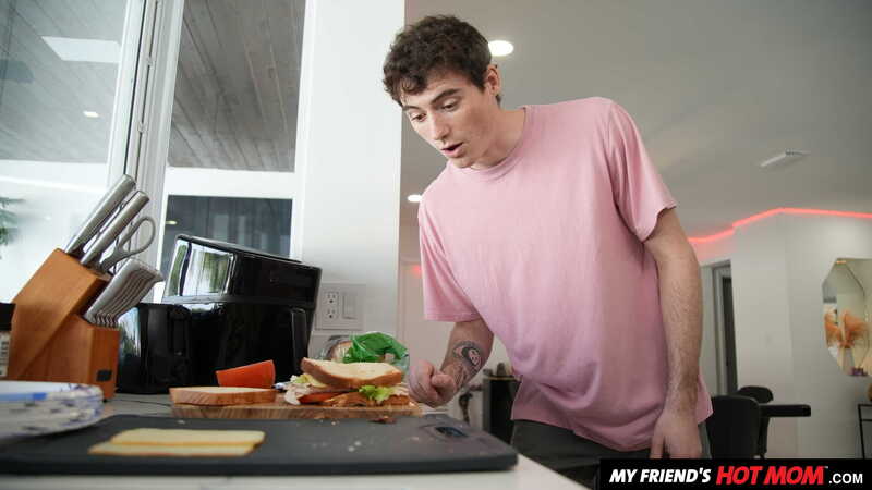 Scene from Naughty America Katalina Kyle porn video 'Sexy Milf Katalina Kyle gets a cock meat sandwich from her son's friend' where Katalina Kyle is making a sandwich in the kitchen.