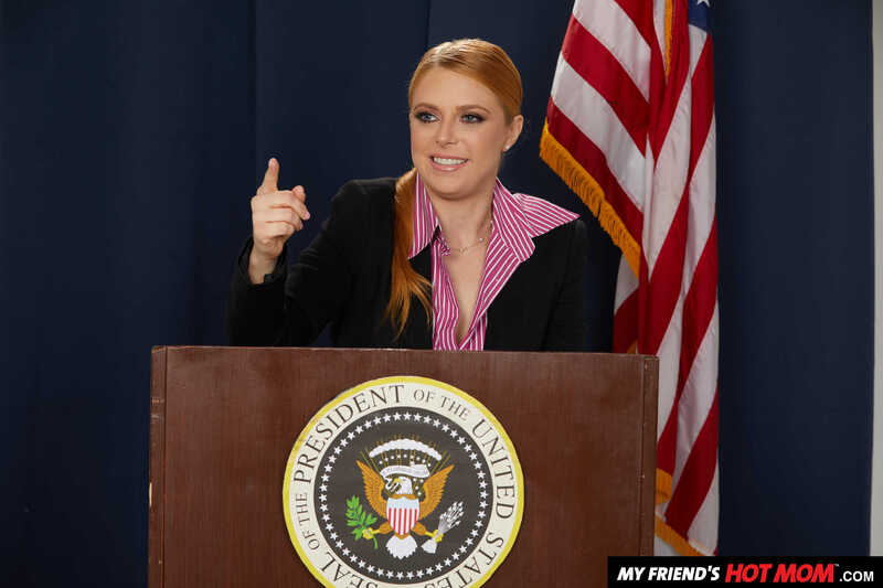 In the Penny Pax My Friend's Hot Mom porn scene 'Penny Pax gives her intern a fuck of his life', Penny Pax ton is standing behind a podium with a seal of the president on it.