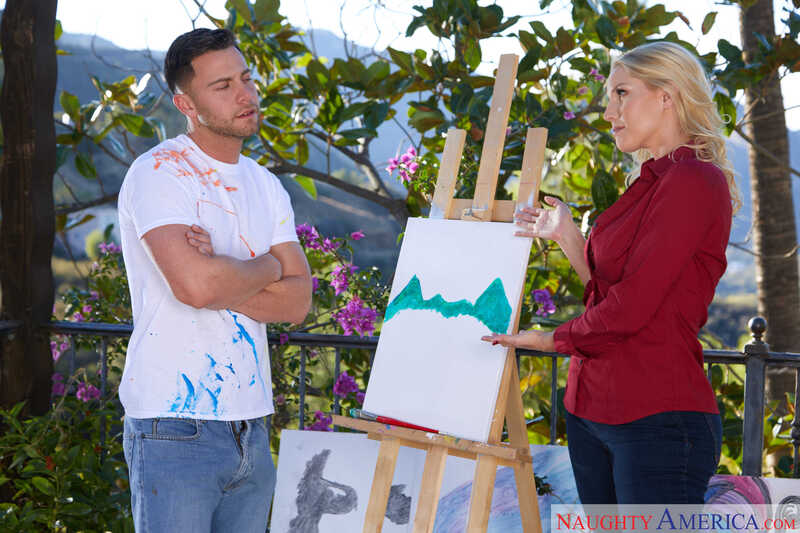 Naughty America Vanessa Cage porn: Vanessa Cage is holding a painting in front of a man.