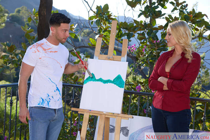 Scene from Naughty America Vanessa Cage porn video 'Mrs. Vanessa Cage Fucks Her Sons Friend ' where Vanessa Cage watches as her boyfriend paints a picture of a mountain.