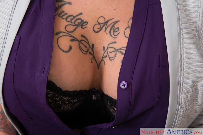 Naughty America Anna Bell Peaks porn: Anna Bell Peaks ' tattooed chest is shown in a purple jacket.