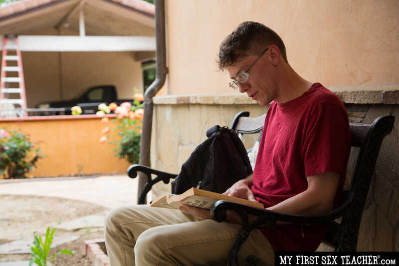 Scene from Naughty America Kenzie Taylor porn video 'Professor McKenna fucks student after class' where Kenzie Taylor is reading a book while sitting on a bench.