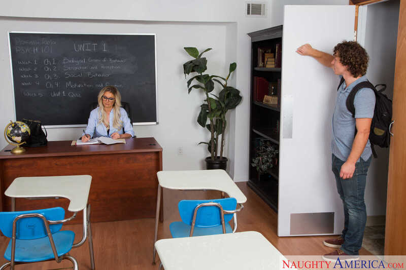 In the Kenzie Taylor My First Sex Teacher porn scene 'Kenzie Taylor fucking in the classroom with her tits', Kenzie Taylor is a sexy teacher in a classroom.