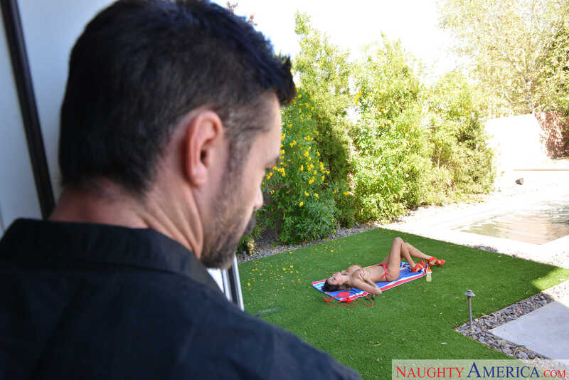 In the Anissa Kate Naughty America porn scene 'Anissa Kate fucking in the couch with her outie pussy' from My Girlfriend's Busty Friend, Anissa Kate is laying on a towel in the grass.