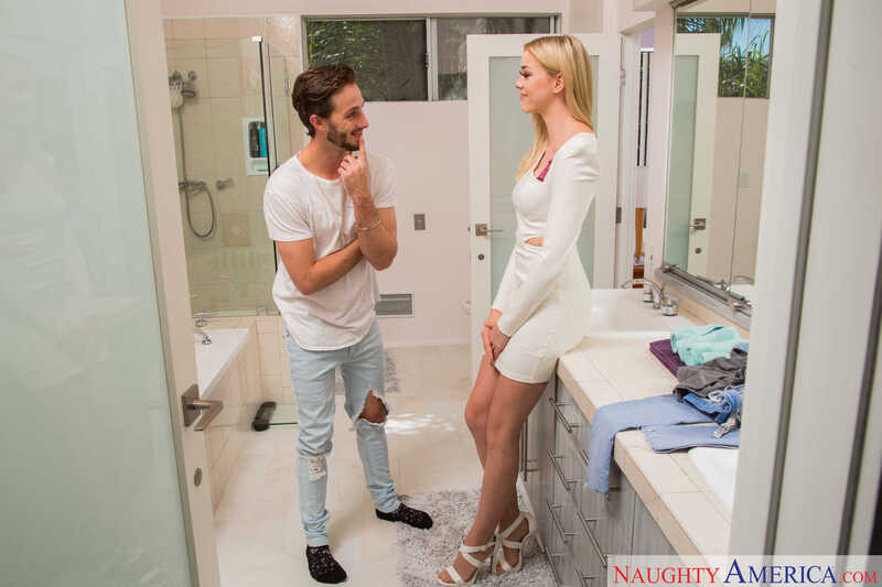 Scene from Naughty America Anny Aurora porn video 'When girls-night-out plans fall through, the next best thing is to fuck my friend's brother.' where Anny Aurora is standing in a bathroom with a man.