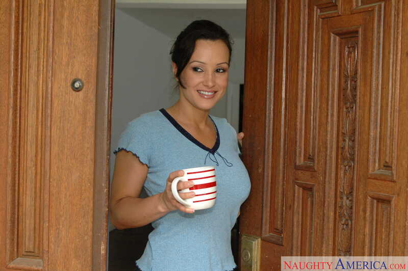 In the Lisa Ann Naughty America porn scene 'Lisa Ann fucking in the living room with her bubble butt' from Neighbor Affair, Lisa Ann is holding a cup of coffee in her hand.