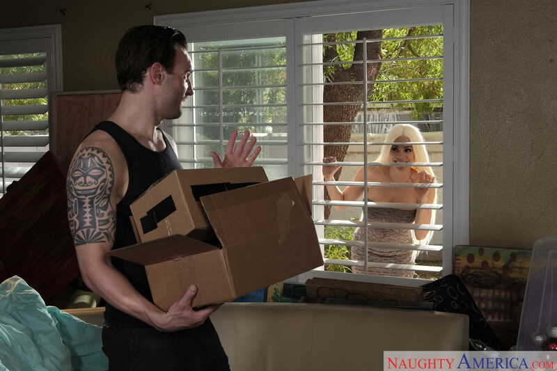 Neighbor Affair Luna Star porn scene 'Luna Star fucking in the living room with her big tits' - Luna Star is behind the window, and the man is holding a box.