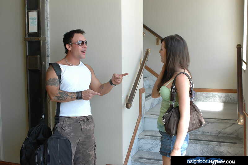 In the Vanessa Lane Neighbor Affair porn scene 'Vanessa Lane gets a big cock', Vanessa Lane is talking to a man in a white tank top.