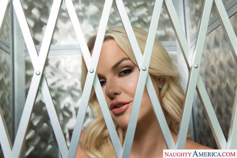 Naughty America Slimthick Vic porn: Slimthick Vic key from Naughty America.com is looking through a metal fence.