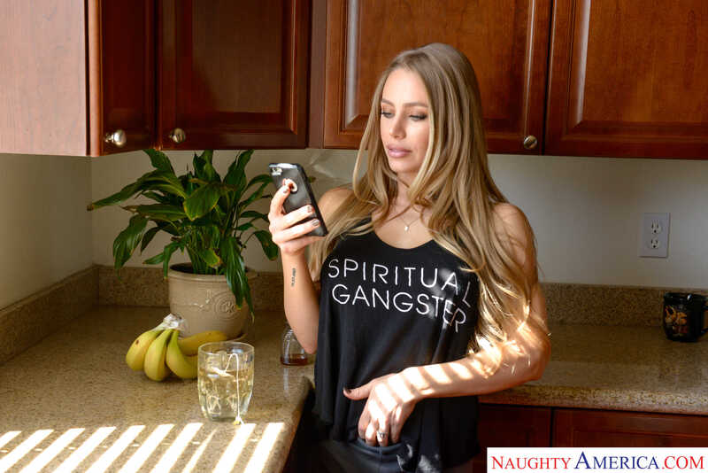 In the Nicole Aniston Mrs. Creampie porn scene 'Nicole Aniston loves a deep, wet creampie', Nicole Aniston is holding a cell phone in her hand.