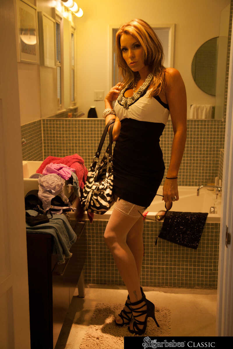 Naughty America Courtney Cummz porn: Courtney Cummz is standing in a bathroom wearing a  and white dress.