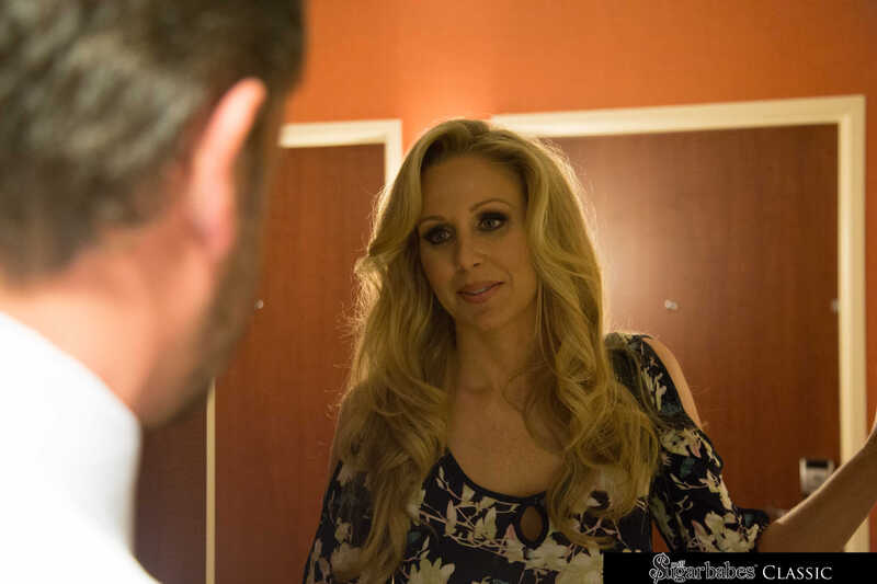 In the Julia Ann Milf Sugar Babes porn scene 'Julia Ann strips and fucks her sugar daddy before dinner', Julia Ann is looking at herself in the mirror.