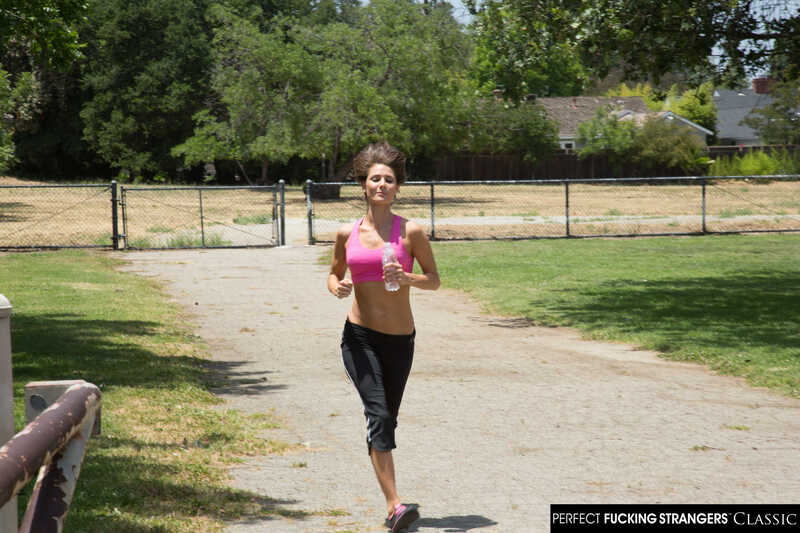 Naughty America Jenni Lee porn: Jenni Lee runs down the road in a pink sports bra.