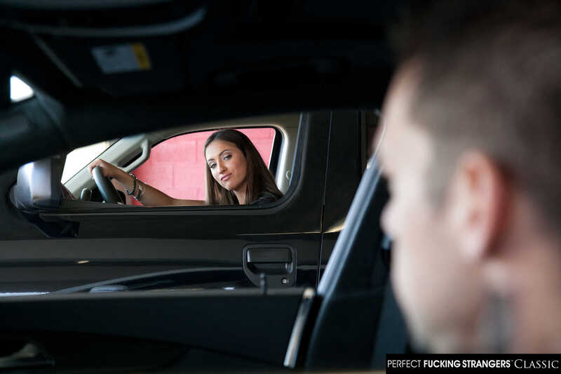 In the Lizz Tayler Naughty America porn scene 'Lizz Tayler fucks parking lot stranger in stairwell' from Perfect Fucking Strangers, Lizz Tayler is in the driver seat of a car.