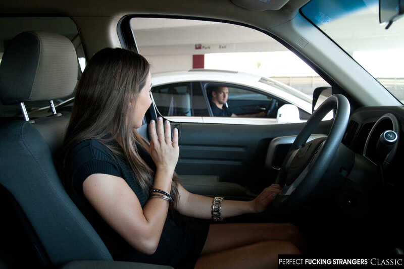 Scene from Naughty America Lizz Tayler porn video 'Lizz Tayler fucks parking lot stranger in stairwell' where Lizz Tayler is in the driver's seat of a car.