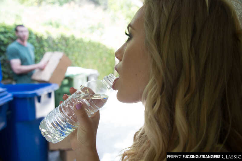 Naughty America Nicole Aniston porn: Nicole Aniston is drinking water from a bottle.