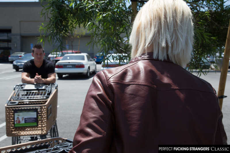 Scene from Naughty America Siri Dahl porn video 'Siri's big tits get wet with cum' where Siri Dahl is in a parking lot with a man in a shopping cart.