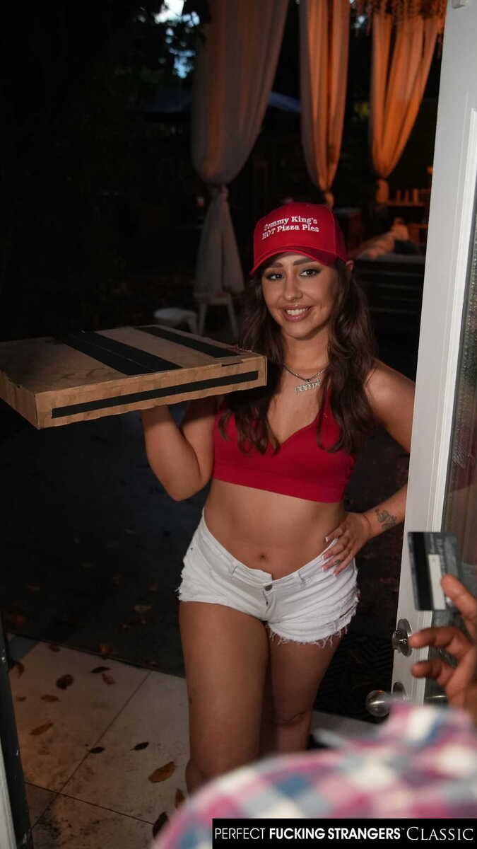 In the Tommy King Naughty America porn scene 'Big booty delivery girl Tommy King takes bbc instead of cash for pizza' from Perfect Fucking Strangers, Tommy King is holding a pizza and wearing a red hat.