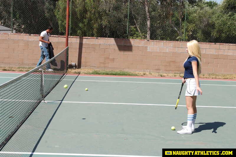 Naughty Athletics Kagney Linn Karter porn scene 'Kagney Linn Karter serves up some outdoor fucking' - Kagney Linn Karter is holding a tennis racket on a tennis court.