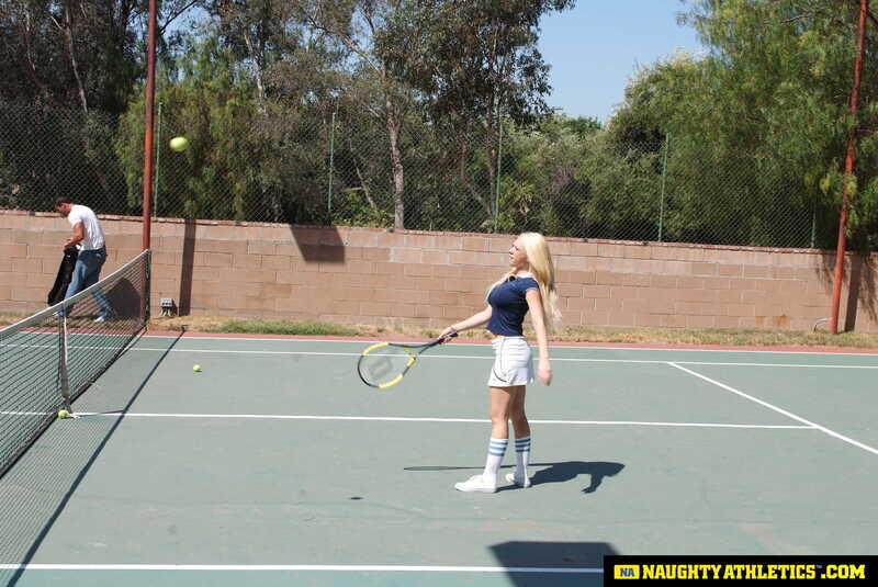 Naughty Athletics Kagney Linn Karter porn scene 'Kagney Linn Karter serves up some outdoor fucking' - Kagney Linn Karter is playing tennis on a court.