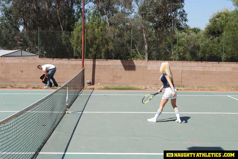 Naughty Athletics Kagney Linn Karter porn scene 'Kagney Linn Karter serves up some outdoor fucking' - Kagney Linn Karter is playing tennis on a court.