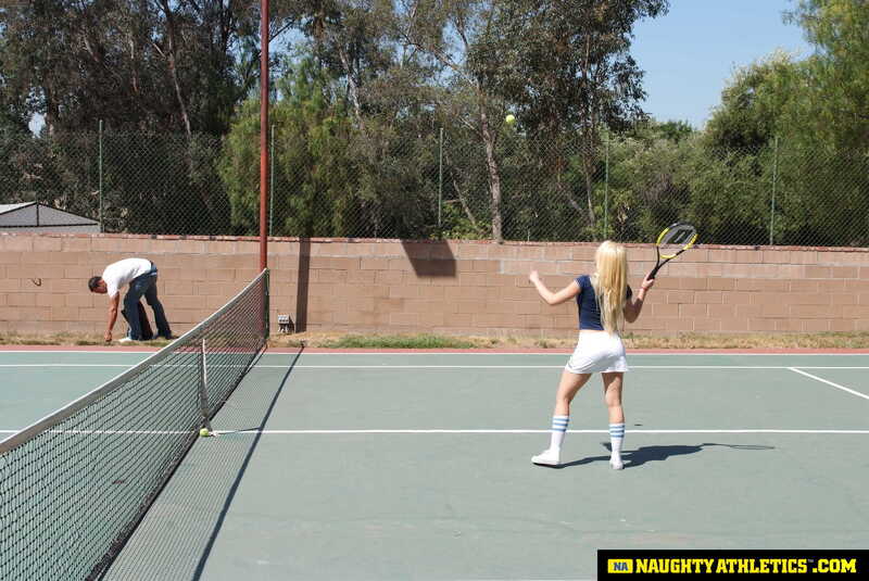 Scene from Naughty America Kagney Linn Karter porn video 'Kagney Linn Karter serves up some outdoor fucking' where Kagney Linn Karter is playing tennis on a court.