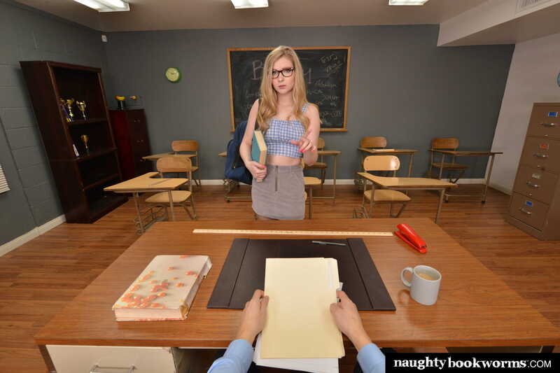 Scene from Naughty America Harlow West porn video 'Harlow West will do anything to drop the course -- even fuck you!!' where Harlow West on is standing in front of a desk with a coffee cup on it.