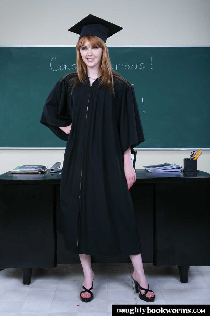 In the Marie McCray Naughty Bookworms porn scene 'Cute redhead Mari McCray fucks her way to graduation', Marie McCray is a sexy, young, redheaded woman wearing a  graduation gown.