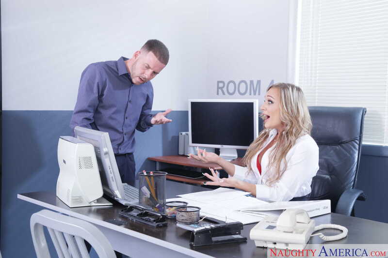 Scene from Naughty America Tucker Stevens porn video 'MILF Tucker Stevens fucking in the office with her blue eyes' where Tucker Stevens is in a room with a woman.