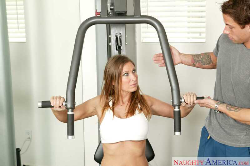 Scene from Naughty America Devon Lee porn video 'panther Devon Lee fucking in the gym equipment with her tits' where Devon Lee Carlson is a fitness model and personal trainer.